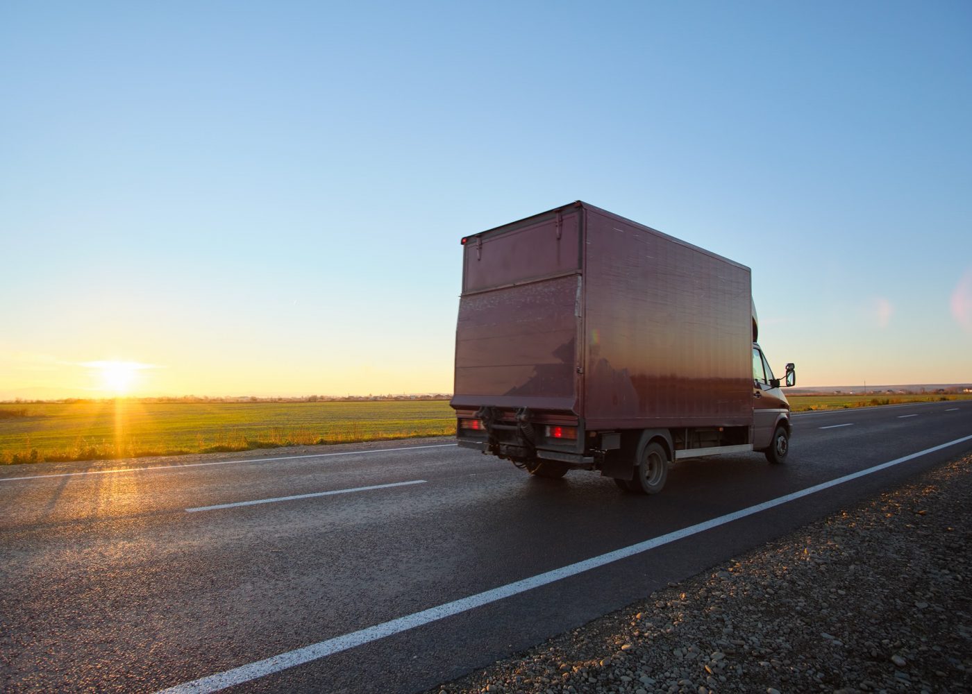 cargo-truck-driving-on-highway-hauling-goods-in-ev-2022-01-31-17-47-32-utc